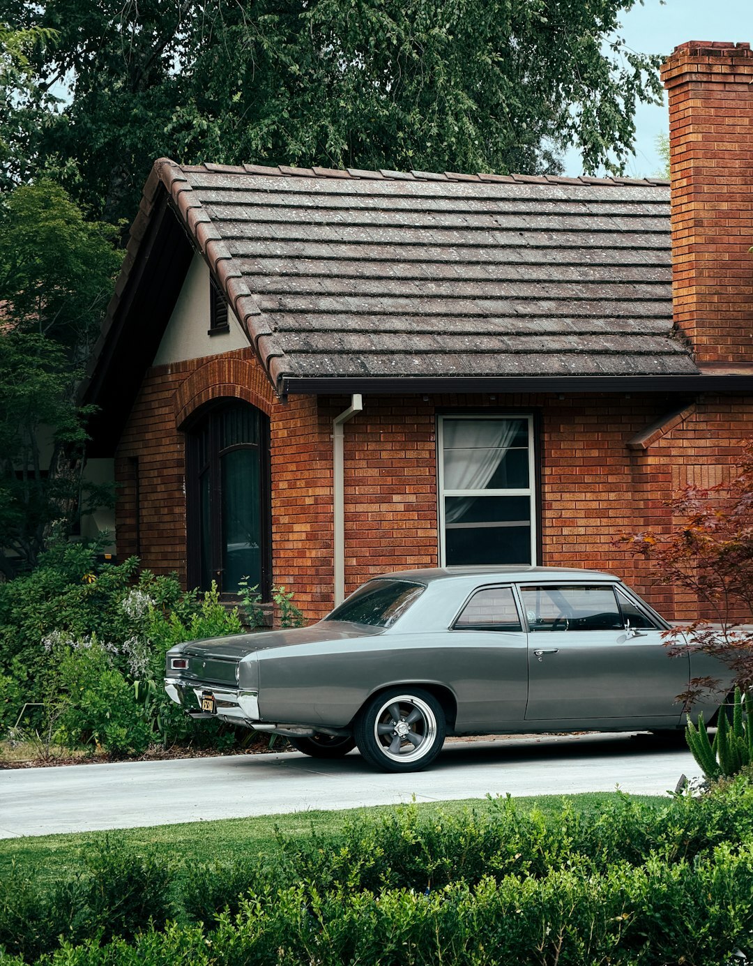 Car parked in driveway of suburban house