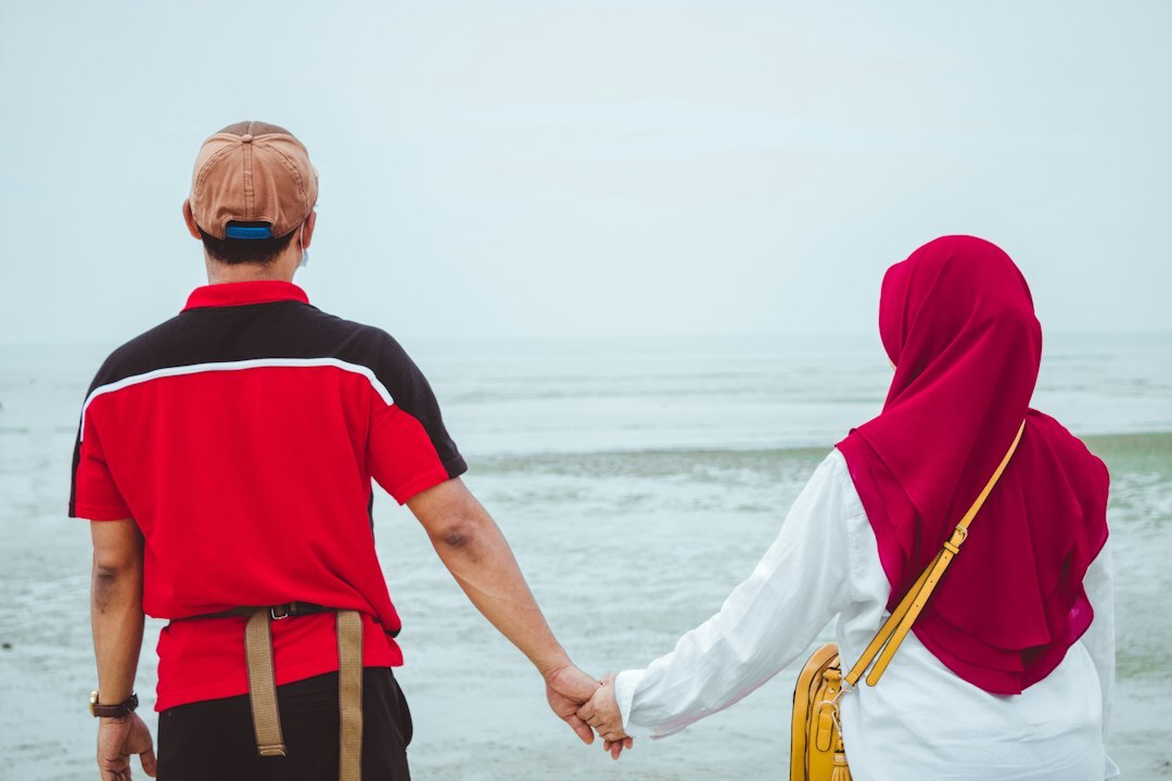 elderly couple walking on beach